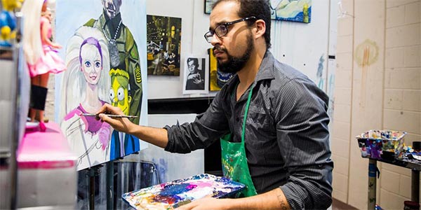 Student painting in studio