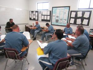7 Students and Dr. Nick DeArmas in a writing class in the Main unit of the Central Florida Reception Center