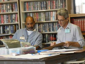 Two men drawing in the library in the South Unit of the Central Florida Reception Center