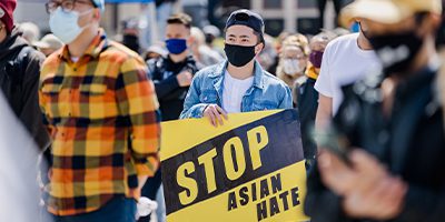 students marching protesting to stop Asian hate