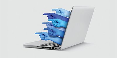hands pointing out of a laptop