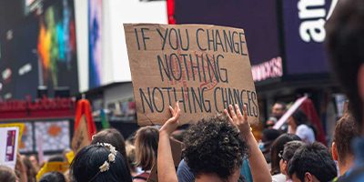 a sign being held at a protest