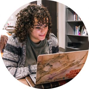 Student reads from laptop