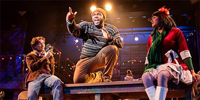Actors sing on stage