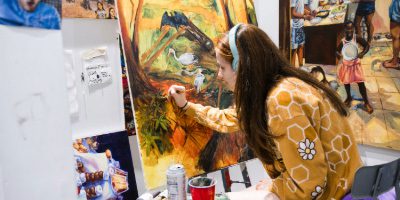 Student painting in studio