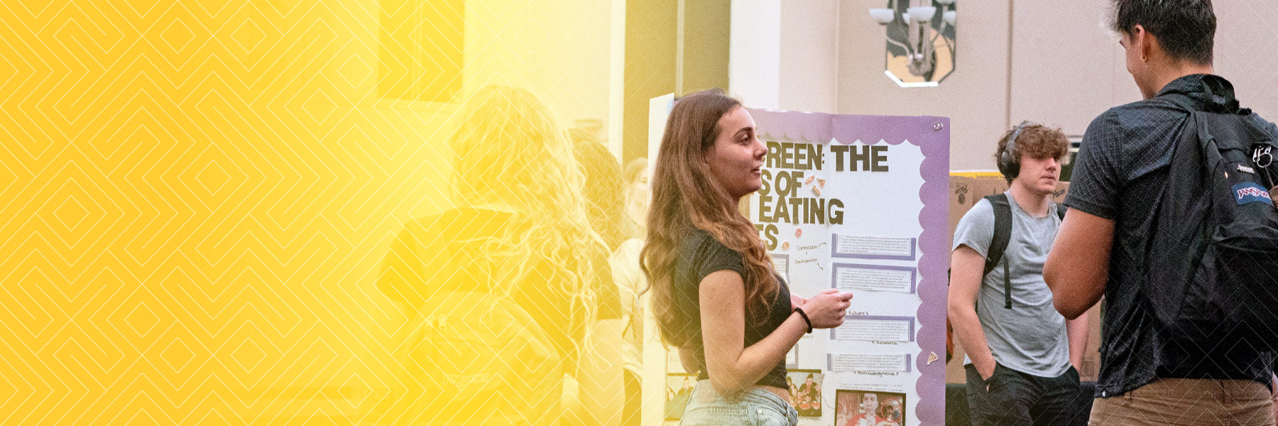 Students converse during poster session.